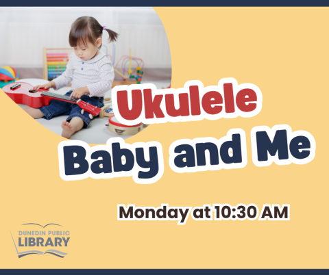 Baby surrounded by ukulele and musical instruments